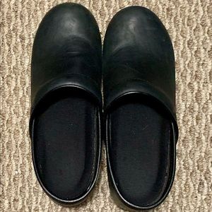 Black Dansko clogs with comfort inserts.